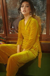 Wrap-style velvet blouse with structured waist and full-length sleeves for tailored elegance